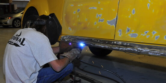 man doing metal work at national auto collision center