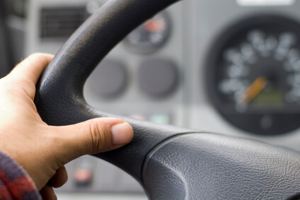 person holding steering wheel practicing safe driving
